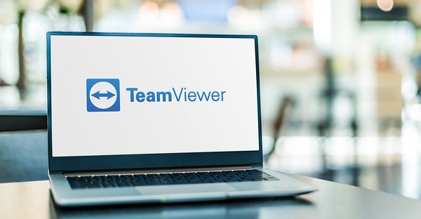 Laptop mit TeamViewer-Logo auf dem Bildschirm in einem unscharfen Hintergrund.